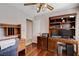 Office with wooden built-in desk, ceiling fan, and hardwood floors at 7624 Nocturne Ct, Las Vegas, NV 89128