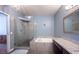 Elegant bathroom featuring a glass shower and a luxurious soaking tub with granite surround and countertop at 7900 Shelter Island Way, Las Vegas, NV 89145