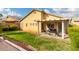 View of a well-maintained backyard featuring green grass, landscaping, and covered patio area at 8233 Valley Stream Ave, Las Vegas, NV 89131