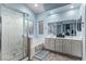 Modern bathroom with a soaking tub, glass shower, and dual sinks at 8233 Valley Stream Ave, Las Vegas, NV 89131