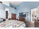 Cozy bedroom featuring blue walls, high ceilings, and a view into other rooms at 8233 Valley Stream Ave, Las Vegas, NV 89131