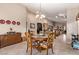 Open-concept dining area with a chandelier and seating for four at 8233 Valley Stream Ave, Las Vegas, NV 89131