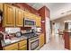 Well-equipped kitchen featuring stainless steel appliances, granite countertops, and warm wood cabinetry at 8233 Valley Stream Ave, Las Vegas, NV 89131