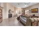 Bright living room with neutral walls, tile flooring and comfortable seating at 8233 Valley Stream Ave, Las Vegas, NV 89131
