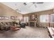 Spacious living room with a fireplace, ceiling fans, and comfortable seating at 8233 Valley Stream Ave, Las Vegas, NV 89131
