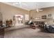 Open living room features plush carpeting, comfortable seating, and archway view of kitchen at 8233 Valley Stream Ave, Las Vegas, NV 89131