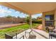View of an outdoor patio area with furniture, a green lawn, and landscaped backyard at 8233 Valley Stream Ave, Las Vegas, NV 89131