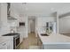 Contemporary kitchen features stainless appliances, center island, and ample white cabinetry at 829 Stepney Pl, Henderson, NV 89011