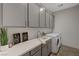 Well-equipped laundry room with modern appliances, gray cabinets and countertop space at 829 Stepney Pl, Henderson, NV 89011