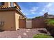 Gated side yard with stone landscaping, offering security and potential for a garden at 8376 Rygate Ave, Las Vegas, NV 89178