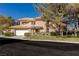 Two-story home with desert landscaping, a tile roof, and a two-car garage at 8481 Heather Downs Dr, Las Vegas, NV 89113