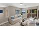 Staged living room with balcony access, comfortable seating, and natural light at 8481 Heather Downs Dr, Las Vegas, NV 89113