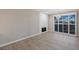 Living room with wood-look flooring, modern fireplace, and sliding door to the backyard at 8481 Heather Downs Dr, Las Vegas, NV 89113