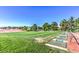 View of a driving range on a lush green golf course with blue skies in the background at 8513 Festival Dr, Las Vegas, NV 89134