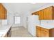 Bright kitchen featuring white appliances, light wood cabinetry, and tile floors at 8513 Festival Dr, Las Vegas, NV 89134