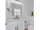 Bathroom with white vanity, black fixtures, modern mirror and decorative plant at 8645 Panuco Way, Las Vegas, NV 89147