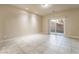 Bright living room with tiled floors and sliding glass doors leading to the backyard at 9772 Toad Hollow St, Las Vegas, NV 89141