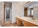 Modern bathroom features double sink vanity and luxurious travertine tile shower at 991 Ridge Path Ave, Henderson, NV 89015