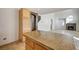 Kitchen island with granite countertops offers a focal point, complementing the nearby fireplace and staircase at 991 Ridge Path Ave, Henderson, NV 89015