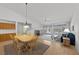 Open-concept dining area with view into living room and carpeted floors at 10808 Aire Dr, Las Vegas, NV 89144