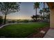 Expansive backyard with green lawn, view fence and desert landscape at 1219 Diamond Valley St, Henderson, NV 89052