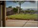 A backyard with a well-maintained lawn, secure fencing, and a view of the surrounding landscape at 1219 Diamond Valley St, Henderson, NV 89052