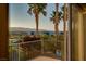 Picturesque balcony view with palm trees and a cityscape in the distance at 1219 Diamond Valley St, Henderson, NV 89052