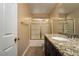 Bathroom featuring granite countertop vanity and shower-tub combination with glass doors at 1219 Diamond Valley St, Henderson, NV 89052