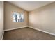 Cozy bedroom with neutral walls, carpet flooring, base trim, and a bright window at 1219 Diamond Valley St, Henderson, NV 89052