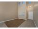 Spacious vacant room features high ceilings, neutral paint, tile/carpet flooring and natural light at 1219 Diamond Valley St, Henderson, NV 89052