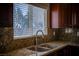 Granite countertop with stainless steel double sink and faucet under window for natural light at 1219 Diamond Valley St, Henderson, NV 89052