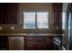 Close-up of a kitchen with dark cabinetry, granite countertops, and stainless steel appliances at 1219 Diamond Valley St, Henderson, NV 89052