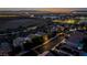 Evening aerial view of a neighborhood featuring well-lit homes, mature trees and city lights at 1219 Diamond Valley St, Henderson, NV 89052