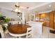 Kitchen with a round table and chairs adjacent to a staircase and living area at 13 White Tail Ct, Henderson, NV 89074