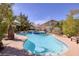 Swimming pool with a spa, tropical foliage, and lounge chairs creating a relaxing backyard oasis at 13 White Tail Ct, Henderson, NV 89074