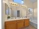 Bathroom features double sinks, vanity and soaking tub with tile surround at 1701 Santa Rosalia Dr, North Las Vegas, NV 89031