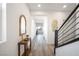 Stylish hallway featuring wood-like flooring, leading to various rooms and staircase at 1722 Game Garden Rd, North Las Vegas, NV 89031