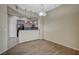 Cozy dining area showcasing wood floors and kitchen pass-through with breakfast bar at 20 E Serene Ave # 304, Las Vegas, NV 89123