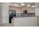 Kitchen with wood cabinets, black appliances, and granite countertops with breakfast bar at 20 E Serene Ave # 304, Las Vegas, NV 89123