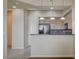 Partial view of kitchen with wood cabinets, modern appliances, and breakfast bar at 20 E Serene Ave # 304, Las Vegas, NV 89123