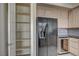 Kitchen boasts stainless steel appliances, wooden cabinets, and a walk-in pantry at 20 E Serene Ave # 304, Las Vegas, NV 89123