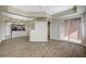 Open-concept living room with wood floors, sliding glass doors and pass-through kitchen view at 20 E Serene Ave # 304, Las Vegas, NV 89123