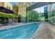 Condo community pool featuring lounge chairs and meticulously maintained landscaping at 20 E Serene Ave # 304, Las Vegas, NV 89123