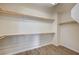 Spacious walk-in closet with wood floor and multiple shelves for optimal organization and storage at 20 E Serene Ave # 304, Las Vegas, NV 89123