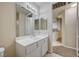 Bathroom with a double vanity and view into the next room at 20 Serene Ave # 201, Las Vegas, NV 89123