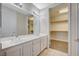 Bathroom with a double vanity, large mirror, and walk in closet at 20 Serene Ave # 201, Las Vegas, NV 89123