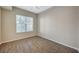Bright bedroom featuring hardwood floors, ceiling fan and large window with blinds at 20 Serene Ave # 201, Las Vegas, NV 89123