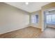 Bedroom with large window and light wood-look floors at 20 Serene Ave # 201, Las Vegas, NV 89123