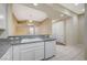 Open kitchen with breakfast bar, white cabinets, granite counters and modern appliances at 20 Serene Ave # 201, Las Vegas, NV 89123