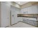 Well-lit kitchen with white cabinets, granite counters and tile flooring at 20 Serene Ave # 201, Las Vegas, NV 89123
